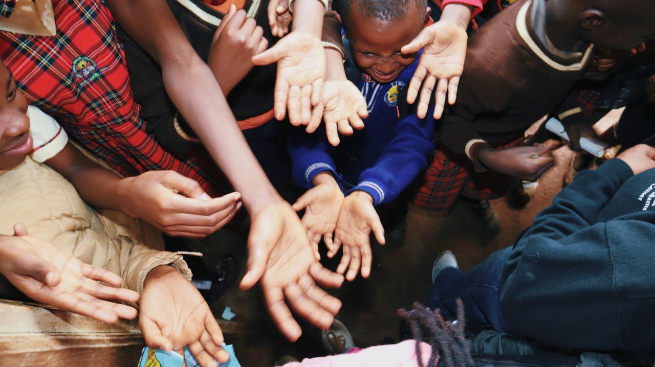 services-04 A diverse group of children reaching out their hands, symbolizing unity and hope.
